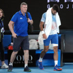 
              Novak Djokovic, right, of Serbia leaves the court with a trainer for an injury time out during his second round match against Enzo Couacaud of France at the Australian Open tennis championship in Melbourne, Australia, Thursday, Jan. 19, 2023. (AP Photo/Dita Alangkara)
            