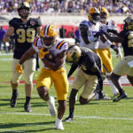 
              LSU running back Noah Cain, center, scores a touchdown as he runs past the Purdue defense including defensive end Jack Sullivan (99) during the first half of the Citrus Bowl NCAA football game, Monday, Jan. 2, 2023, in Orlando, Fla. (AP Photo/John Raoux)
            