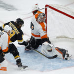 
              Boston Bruins right wing David Pastrnak scores past Philadelphia Flyers goaltender Carter Hart and center Kevin Hayes during the first period of an NHL hockey game, Monday, Jan. 16, 2023, in Boston. (AP Photo/Mary Schwalm)
            