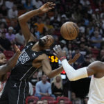 
              Miami Heat forward Haywood Highsmith, left, swats the ball away from Brooklyn Nets forward Kevin Durant, center, as center Bam Adebayo (13) attempts to catch the ball during the first half of an NBA basketball game, Sunday, Jan. 8, 2023, in Miami. (AP Photo/Wilfredo Lee)
            