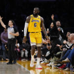 
              Los Angeles Lakers' LeBron James (6) and fans celebrate a three-point basket by James during the second half of an NBA basketball game against the Houston Rockets Monday, Jan. 16, 2023, in Los Angeles. The Lakers won 140-132. (AP Photo/Jae C. Hong)
            