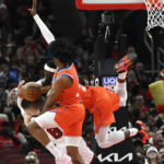 
              Chicago Bulls guard Zach LaVine (8) fights for a rebound against Oklahoma City Thunder forward Jalen Williams, front, and guard Luguentz Dort, back, during the first half of an NBA basketball game Friday, Jan. 13, 2023, in Chicago. (AP Photo/Matt Marton)
            
