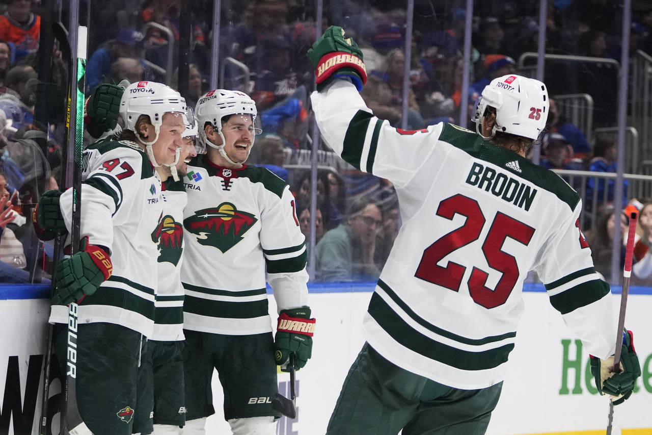 Minnesota Wild's Sam Steel, second from right, celebrates with teammates after scoring a goal again...