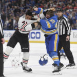 
              St. Louis Blues' Ivan Barbashev (49) and Chicago Blackhawks' Isaak Phillips (41) fight during the second period of an NHL hockey game Saturday, Jan. 21, 2023, in St. Louis. (AP Photo/Michael Thomas)
            