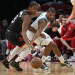 
              Charlotte Hornets' Dennis Smith Jr., right, reaches in to steal the ball from Houston Rockets' Josh Christopher (9) during the first half of an NBA basketball game Wednesday, Jan. 18, 2023, in Houston. (AP Photo/David J. Phillip)
            