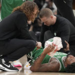
              Trainers tend to Boston Celtics guard Marcus Smart after an injury during first-half NBA basketball game action against the Toronto Raptors in Toronto, Saturday, Jan. 21, 2023. (Frank Gunn/The Canadian Press via AP)
            