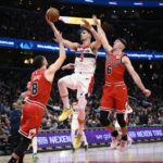 
              Washington Wizards forward Deni Avdija (9) goes to the basket against Chicago Bulls guard Zach LaVine (8), guard Alex Caruso (6) and forward Patrick Williams (44) during the second half of an NBA basketball game Wednesday, Jan. 11, 2023, in Washington. The Wizards won 100-97. (AP Photo/Nick Wass)
            