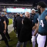 
              Philadelphia Eagles owner Jeffrey Lurie, center, reacts with linebacker Haason Reddick (7) and defensive end Josh Sweat (94) following an NFL divisional round playoff football game against the New York Giants, Saturday, Jan. 21, 2023, in Philadelphia. The Eagles won 38-7. (AP Photo/Matt Slocum)
            