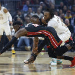 
              Miami Heat guard Victor Oladipo and Cleveland Cavaliers guard Darius Garland scramble for a loose ball during the first half of an NBA basketball game, Tuesday, Jan. 31, 2023, in Cleveland. (AP Photo/Ron Schwane)
            