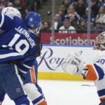 
              New York Islanders goaltender Ilya Sorokin (30) watches the puck as Toronto Maple Leafs center Calle Jarnkrok (19) battles in front of the net during second-period NHL hockey game action in Toronto, Ontario, Monday, Jan. 23, 2023. (Nathan Denette/The Canadian Press via AP)
            