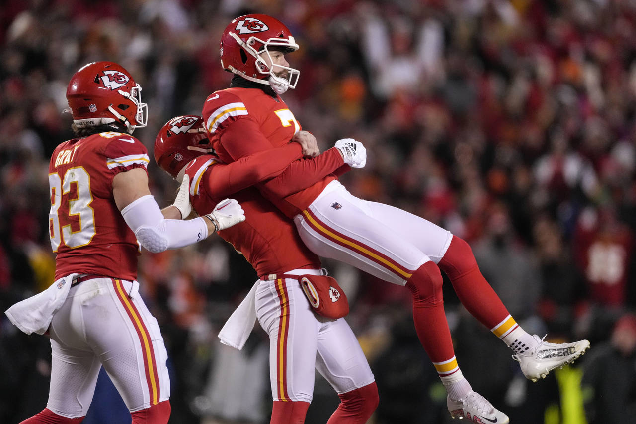 Kansas City Chiefs place kicker Harrison Butker (7) is lifted in the air after his game-winning fie...