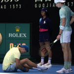 
              Ugo Humbert, right, of France checks on Holger Rune of Denmark after a fall during their third round match at the Australian Open tennis championship in Melbourne, Australia, Saturday, Jan. 21, 2023. (AP Photo/Dita Alangkara)
            