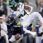 
              Seattle Seahawks safety Johnathan Abram (23) breaks up a pass intended for New York Jets wide receiver Corey Davis (84) during the second half of an NFL football game, Sunday, Jan. 1, 2023, in Seattle. (AP Photo/Godofredo A. Vásquez)
            