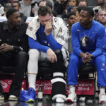 
              Dallas Mavericks guard Luka Doncic, center, sits on the bench during the first half of an NBA basketball game against the Los Angeles Clippers Tuesday, Jan. 10, 2023, in Los Angeles. (AP Photo/Mark J. Terrill)
            