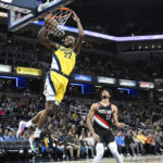 
              Indiana Pacers forward Isaiah Jackson (22) dunks in front of Portland Trail Blazers guard Shaedon Sharpe (17) during the first quarter of an NBA basketball game, Friday, Jan. 6, 2023, in Indianapolis. (AP Photo/Marc Lebryk)
            