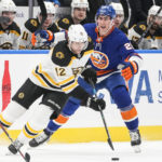 
              Boston Bruins' Craig Smith (12) fights for control of the puck with New York Islanders' Brock Nelson (29) during the first period of an NHL hockey game Wednesday, Jan. 18, 2023, in Elmont, N.Y. (AP Photo/Frank Franklin II)
            