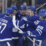 
              Toronto Maple Leafs center Auston Matthews (34) celebrates his goal against the Winnipeg Jets with teammates during the second period of an NHL hockey game, Thursday, Jan. 19, 2023 in Toronto. (Nathan Denette/The Canadian Press via AP)
            