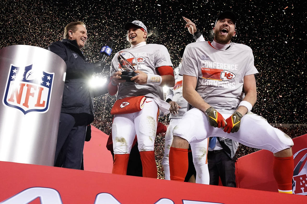 Kansas City Chiefs quarterback Patrick Mahomes and tight end Travis Kelce, right, celebrate with th...
