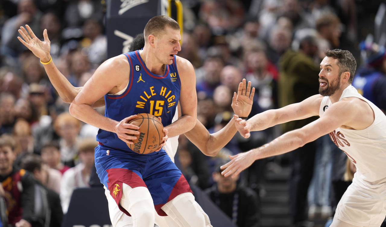 Denver Nuggets center Nikola Jokic, front left, is caught with the ball by Cleveland Cavaliers cent...