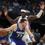
              Dallas Mavericks guard Luka Doncic (77) is guarded by Detroit Pistons center Jalen Duren, top, in the first half of an NBA basketball game Monday, Jan. 30, 2023, in Dallas. (AP Photo/Richard W. Rodriguez)
            