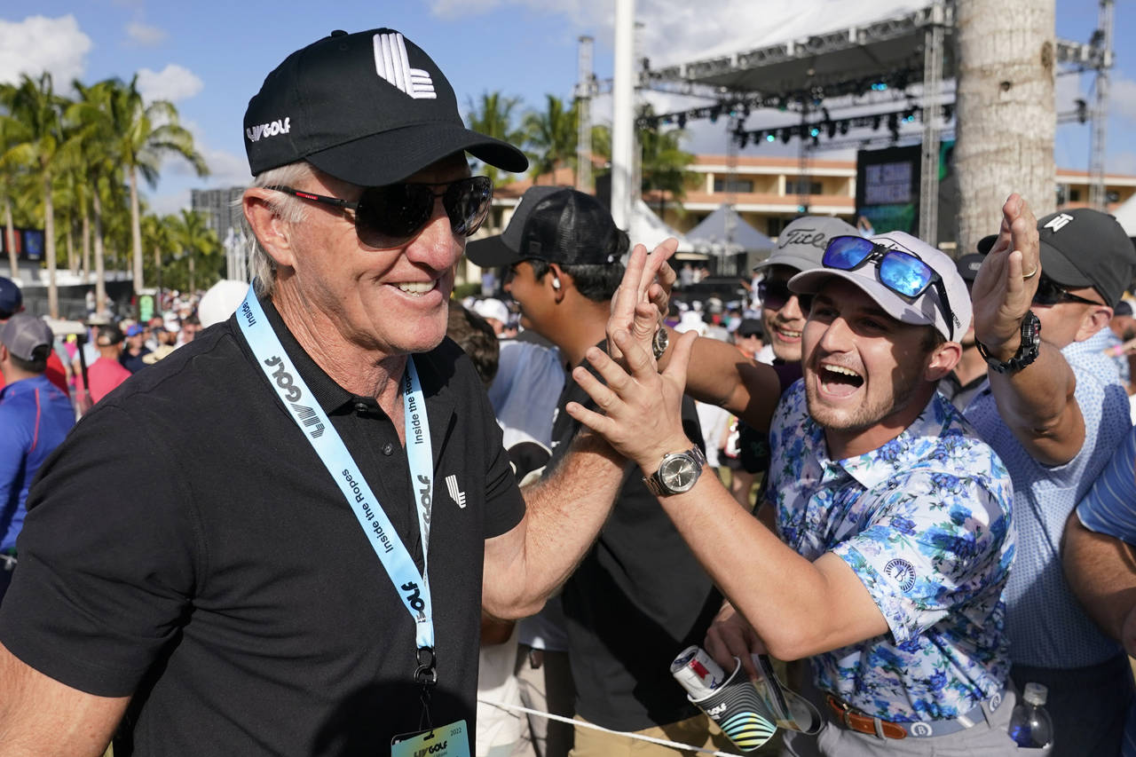 FILE - LIV Golf CEO Greg Norman, left, walks off the course after the final round of the LIV Golf T...