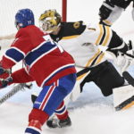 
              Montreal Canadiens' Kirby Dach scores against Boston Bruins goaltender Jeremy Swayman during the third period of an NHL hockey game in Montreal, Tuesday, Jan. 24, 2023. (Graham Hughes/The Canadian Press via AP)
            