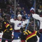 
              Colorado Avalanche's Mikko Rantanen, back, celebrates his goal against the Vancouver Canucks during the second period of an NHL hockey game Friday, Jan. 20, 2023, in Vancouver, British Columbia. (Darryl Dyck/The Canadian Press via AP)
            
