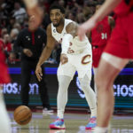
              Cleveland Cavaliers guard Donovan Mitchell points during the first half of an NBA basketball game against the Portland Trail Blazers in Portland, Ore., Thursday, Jan. 12, 2023. (AP Photo/Craig Mitchelldyer)
            