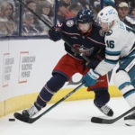 
              Columbus Blue Jackets' Andrew Peeke, left, and San Jose Sharks' Steven Lorentz fight for a loose puck during the first period of an NHL hockey game on Saturday, Jan. 21, 2023, in Columbus, Ohio. (AP Photo/Jay LaPrete)
            
