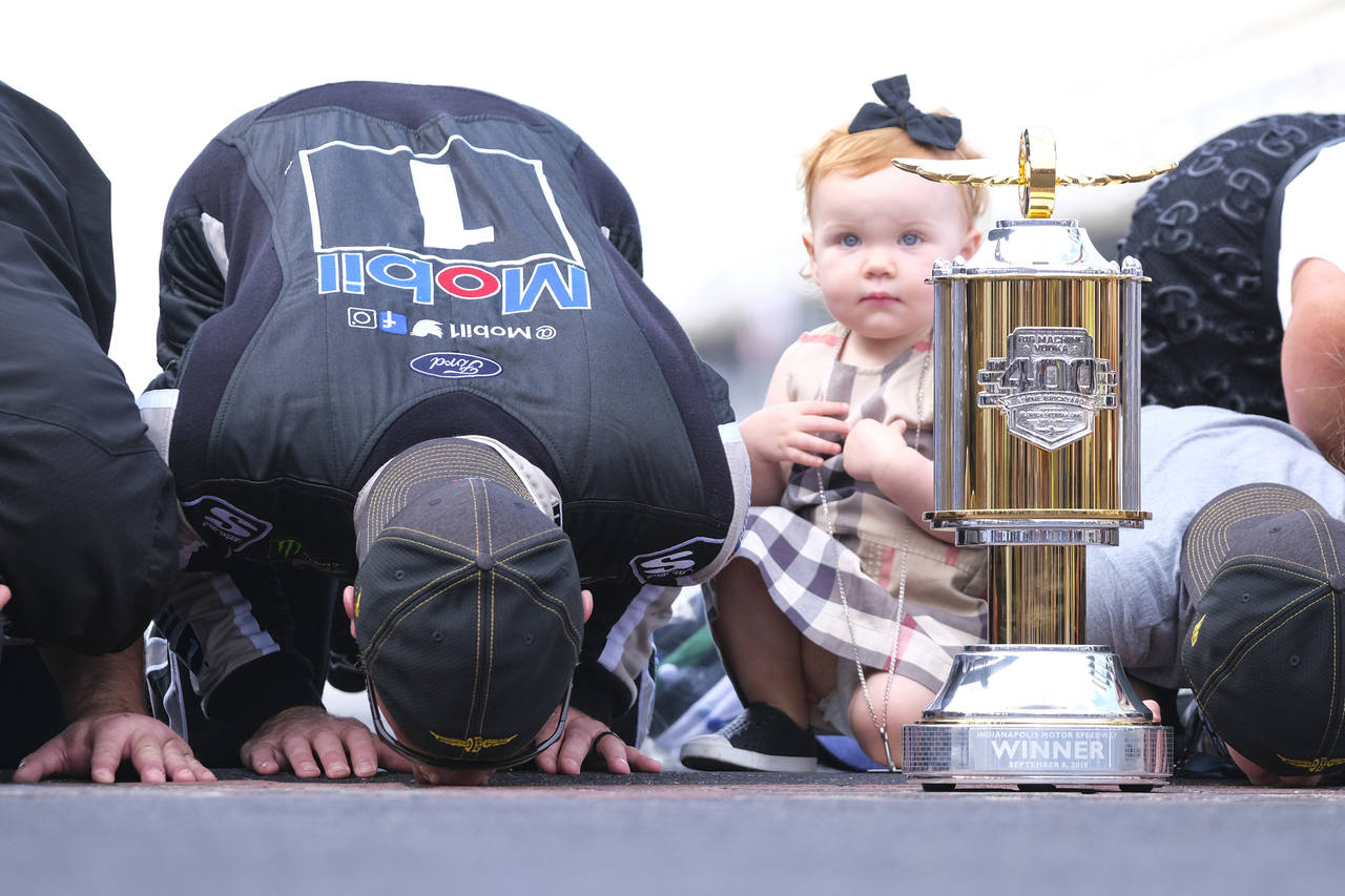 FILE - Piper Harvick looks on as her father Kevin Harvick kisses the yard of bricks on the finish l...