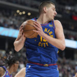 
              Denver Nuggets center Nikola Jokic pulls in a rebound against the Cleveland Cavaliers in the first half of an NBA basketball game Friday, Jan. 6, 2023, in Denver. (AP Photo/David Zalubowski)
            
