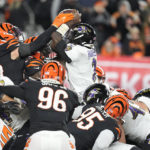 
              Baltimore Ravens quarterback Tyler Huntley (2) fumbles the ball as it is knocked away by Cincinnati Bengals linebacker Logan Wilson, left, in the second half of an NFL wild-card playoff football game in Cincinnati, Sunday, Jan. 15, 2023. The Bengals' Sam Hubbard recovered the fumble and ran it back for a touchdown. ( (AP Photo/Darron Cummings)
            