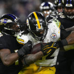 
              Pittsburgh Steelers running back Najee Harris (22) is tackled by Baltimore Ravens linebacker Roquan Smith (18) and defensive tackle Travis Jones (98) in the second half of an NFL football game in Baltimore, Fla., Sunday, Jan. 1, 2023. (AP Photo/Nick Wass)
            
