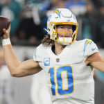 
              Los Angeles Chargers quarterback Justin Herbert (10) works in the pocket against the Jacksonville Jaguars during the first half of an NFL wild-card football game, Saturday, Jan. 14, 2023, in Jacksonville, Fla. (AP Photo/Chris O'Meara)
            