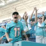 
              Miami Dolphins fans cheer as the team defeats the New York Jets during an NFL football game, Sunday, Jan. 8, 2023, in Miami Gardens, Fla. The Dolphins defeated the Jets 11-6 to advance to the post-season. (AP Photo/Lynne Sladky)
            
