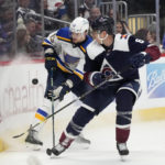 
              St. Louis Blues right wing Alexey Toropchenko, back, fights for control of the puck with Colorado Avalanche defenseman Erik Johnson in the second period of an NHL hockey game Saturday, Jan. 28, 2023, in Denver. (AP Photo/David Zalubowski)
            