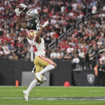 
              Las Vegas Raiders tight end Darren Waller (83) leaps to make a catch while being defended by San Francisco 49ers cornerback Deommodore Lenoir (38) during the first half of an NFL football game between the San Francisco 49ers and Las Vegas Raiders, Sunday, Jan. 1, 2023, in Las Vegas. (AP Photo/David Becker)
            