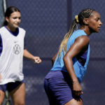 
              U.S. national team players Crystal Dunn, right, and Sophie Smith practice for a match against Nigeria Tuesday, Aug. 30, 2022, in Riverside, Mo. Women’s soccer in the United States has struggled with diversity, starting with a pay-to-play model that can exclude talented kids from communities of color. (AP Photo/Charlie Riedel)
            