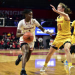 
              In this photo provided by Rutgers, Rutgers' Awa Sidibe, left, drives with the basketball as Maryland's Abby Meyers (10) defends during an NCAA college basketball game in Piscataway, N.J., Monday, Jan. 2, 2023. Sidibe wore the ceremonial No. 1 jersey given to coach Coquese Washington when she was hired in May after the Rutgers guard got blood on her uniform during the game. (Thomas Gilbert/Rutgers Athletics via AP)
            