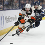 
              Anaheim Ducks' Dmitry Kulikov, left, tries to clear the puck as Columbus Blue Jackets' Eric Robinson defends during the second period of an NHL hockey game Thursday, Jan. 19, 2023, in Columbus, Ohio. (AP Photo/Jay LaPrete)
            
