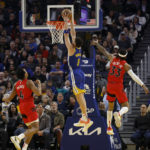 
              Golden State Warriors guard Klay Thompson (11) shoots against Toronto Raptors forward Scottie Barnes (4) and guard Gary Trent Jr. (33) during the first half of an NBA basketball game in San Francisco, Friday, Jan. 27, 2023. (AP Photo/Jed Jacobsohn)
            