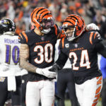 
              Cincinnati Bengals safety Vonn Bell (24) and safety Jessie Bates III (30) celebrate as Baltimore Ravens wide receiver Demarcus Robinson (10) is seen in the background following an NFL wild-card playoff football game in Cincinnati, Sunday, Jan. 15, 2023. The Bengals won 24-17. (AP Photo/Joshua A. Bickel)
            