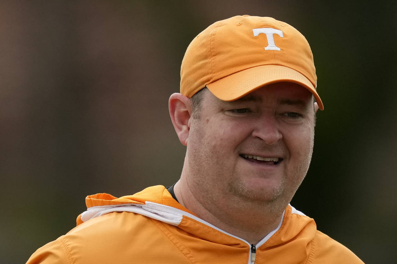 FILE -  Tennessee NCAA college football coach Josh Heupel looks on during a team practice session a...