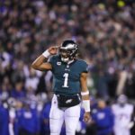 
              Philadelphia Eagles quarterback Jalen Hurts reacts after throwing a touchdown pass to wide receiver DeVonta Smith during the first half of an NFL divisional round playoff football game against the New York Giants, Saturday, Jan. 21, 2023, in Philadelphia. (AP Photo/Matt Slocum)
            