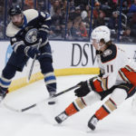 
              Columbus Blue Jackets' Erik Gudbranson, left, clears the puck past Anaheim Ducks' Trevor Zegras during the first period of an NHL hockey game Thursday, Jan. 19, 2023, in Columbus, Ohio. (AP Photo/Jay LaPrete)
            
