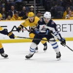 
              Winnipeg Jets center Cole Perfetti (91) takes the puck past Nashville Predators right wing Nino Niederreiter (22) during the first period of an NHL hockey game Tuesday, Jan. 24, 2023, in Nashville, Tenn. (AP Photo/Mark Zaleski)
            