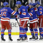 
              New York Rangers defenseman K'Andre Miller (79) is congratulated by Vincent Trocheck after scoring a goal late in the third period of an NHL hockey game against the Dallas Stars, Thursday, Jan. 12, 2023, in New York. (AP Photo/Adam Hunger)
            