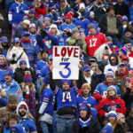 
              Fans hold signs in support of safety Damar Hamlin before an NFL football game against the New England Patriots, Sunday, Jan. 8, 2023, in Orchard Park, N.Y. Hamlin remains hospitalized after suffering a catastrophic on-field collapse in the team's previous game against the Cincinnati Bengals. (AP Photo/Jeffrey T. Barnes)
            