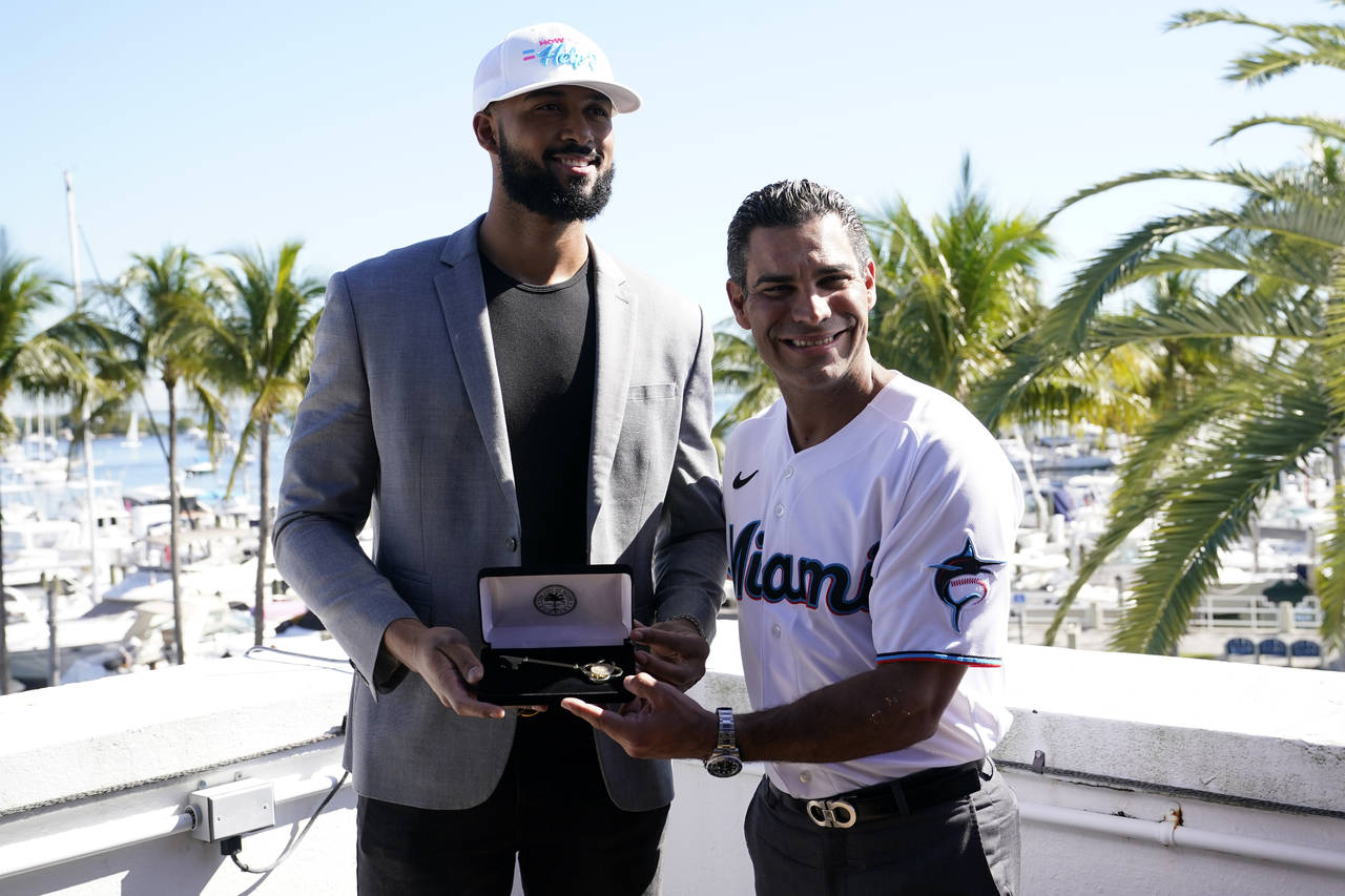 Miami Marlins pitcher Sandy Alcantara, left, the 2022 National League Cy Young winner, holds the ke...