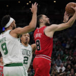 
              Chicago Bulls guard Zach LaVine (8) drives to the basket past Boston Celtics guard Derrick White (9) during the first half of an NBA basketball game, Monday, Jan. 9, 2023, in Boston. (AP Photo/Charles Krupa)
            